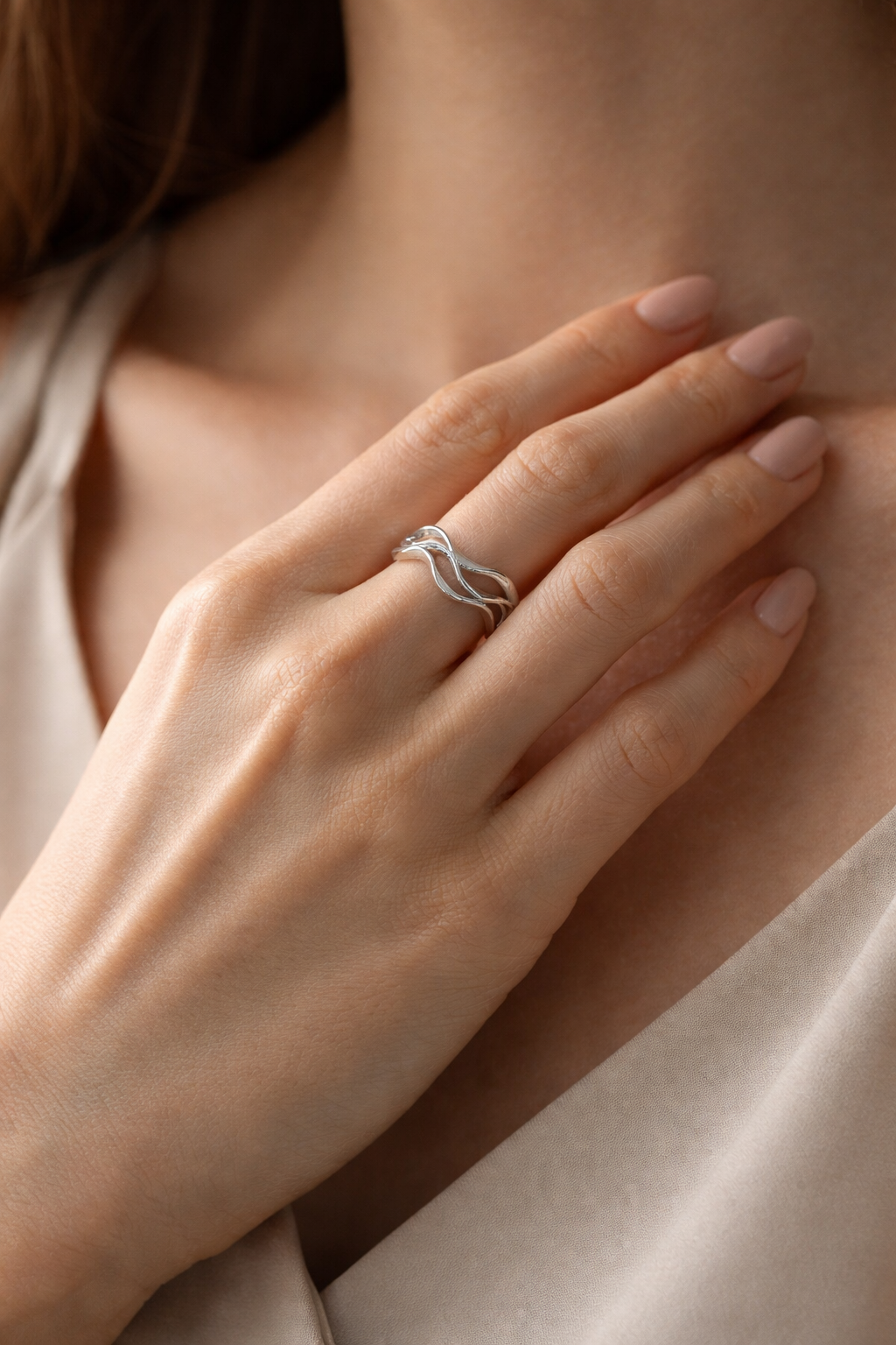 Model wearing the silver Ripple Ring, showcasing the flattering wavy silhouette.