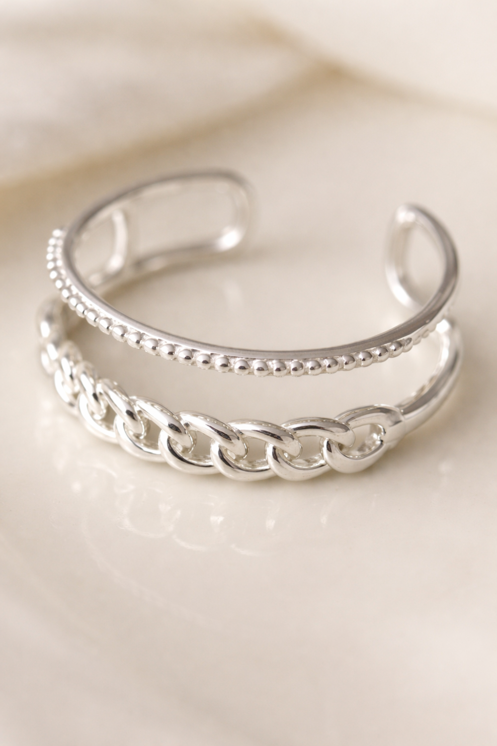 Close-up detail of the Tessa Ring's intricate chain and beaded texture.